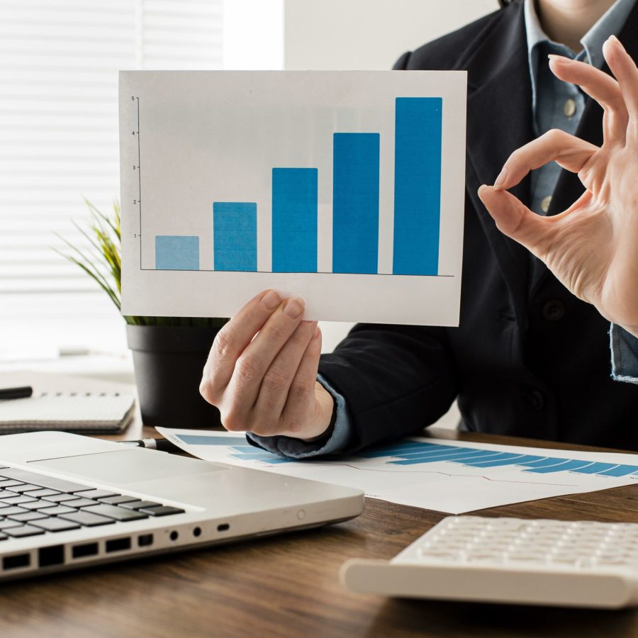 businessman-doing-ok-sign-while-holding-growth-chart